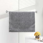 Gray terry hand towel with a woven basketweave dobby texture on a bar