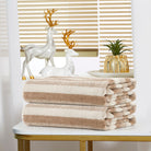 Folded taupe-and-cream striped terry hand towels