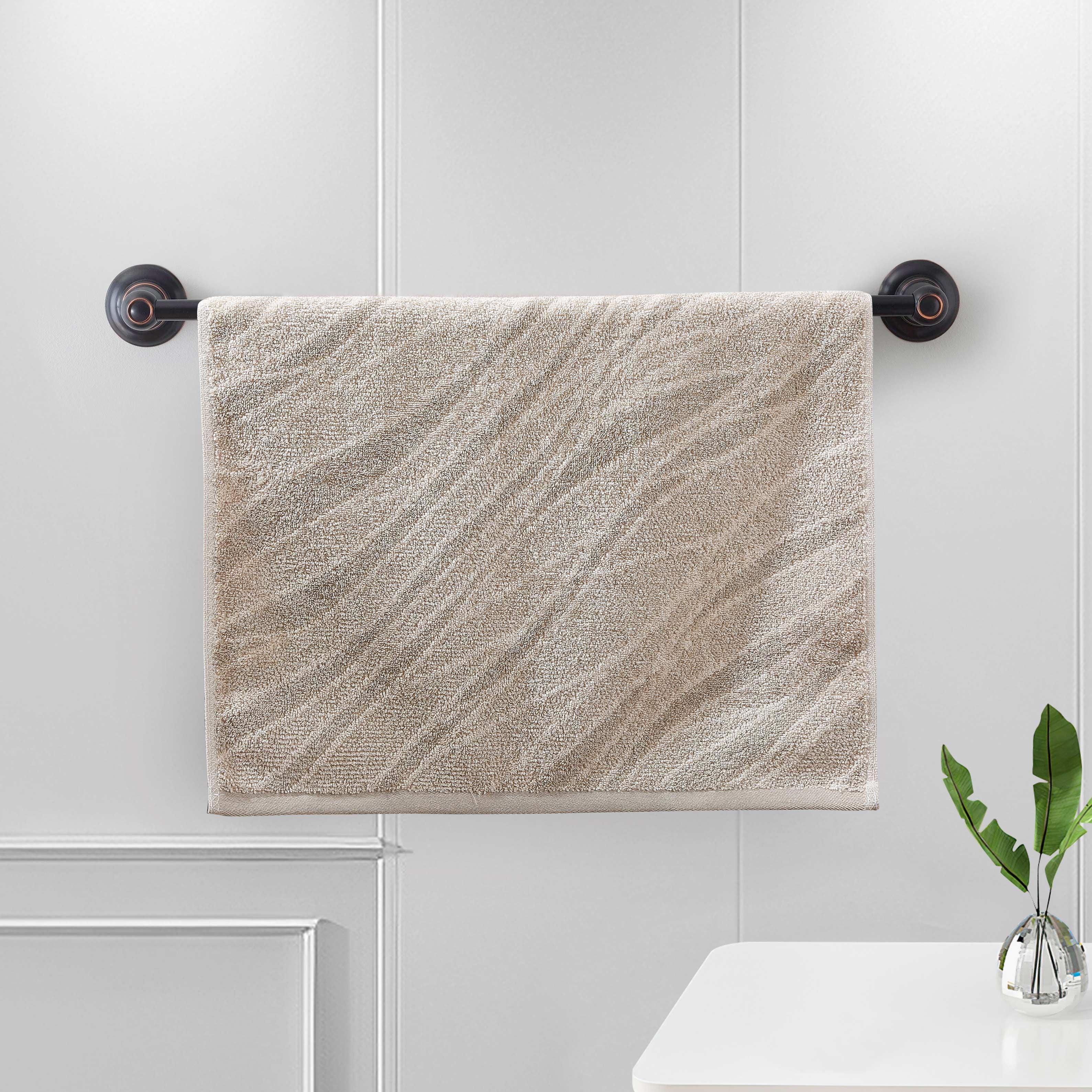 Sand terry hand towel with a woven diagonal wave-stripe pattern on a bar