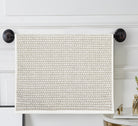 Cream terry hand towel with an all-over small taupe woven pattern