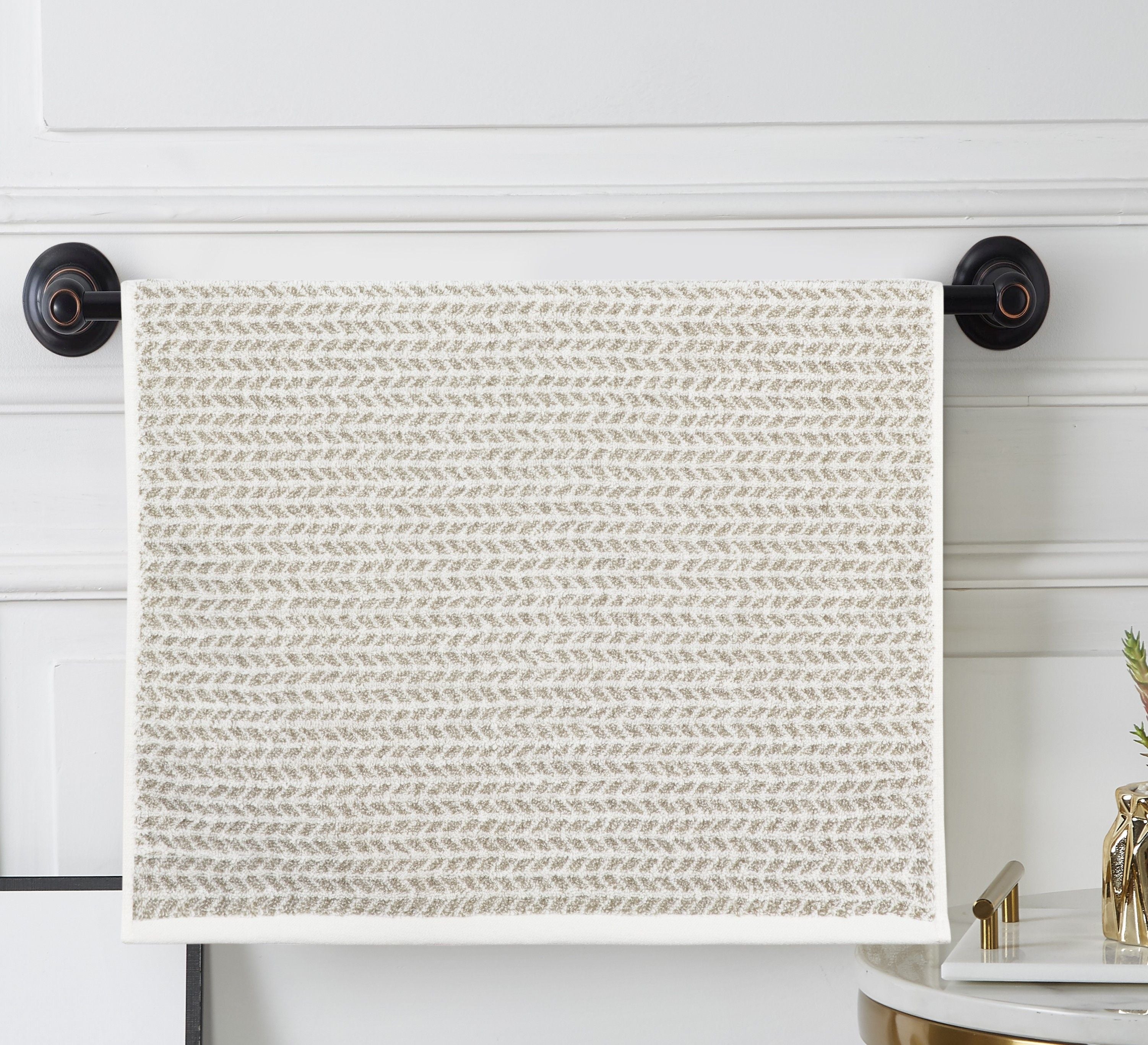 Cream terry hand towel with an all-over small taupe woven pattern