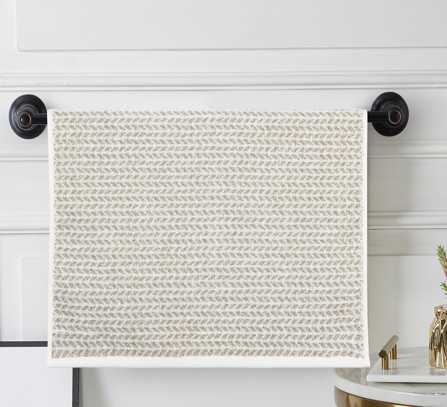 Cream terry hand towel with an all-over small taupe woven pattern