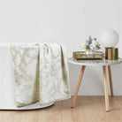 Grey marbled terry hand towel draped over the edge of a bathtub