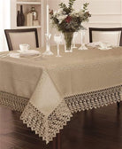 White damask tablecloth with a deep macramé lace border and corner medallions, set on a dining table