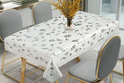 White tablecloth printed with fine grey botanical sprigs of leaves and berries