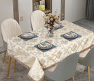 Ivory damask tablecloth with a scalloped lace-and-embroidery border on a set table