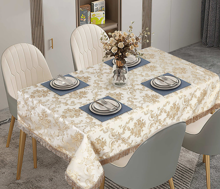 Ivory damask tablecloth with a scalloped lace-and-embroidery border on a set table