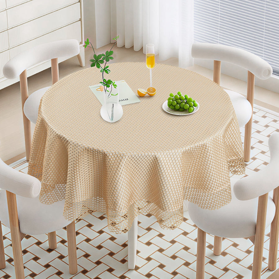 Ivory open square-net lace tablecloth with a scalloped crochet edge on a round table