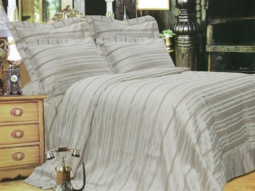 Champagne tonal-stripe sateen duvet set with matching pillow shams made up on a bed