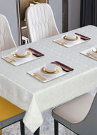 White tone-on-tone woven damask tablecloth with a subtle zigzag texture on a modern table