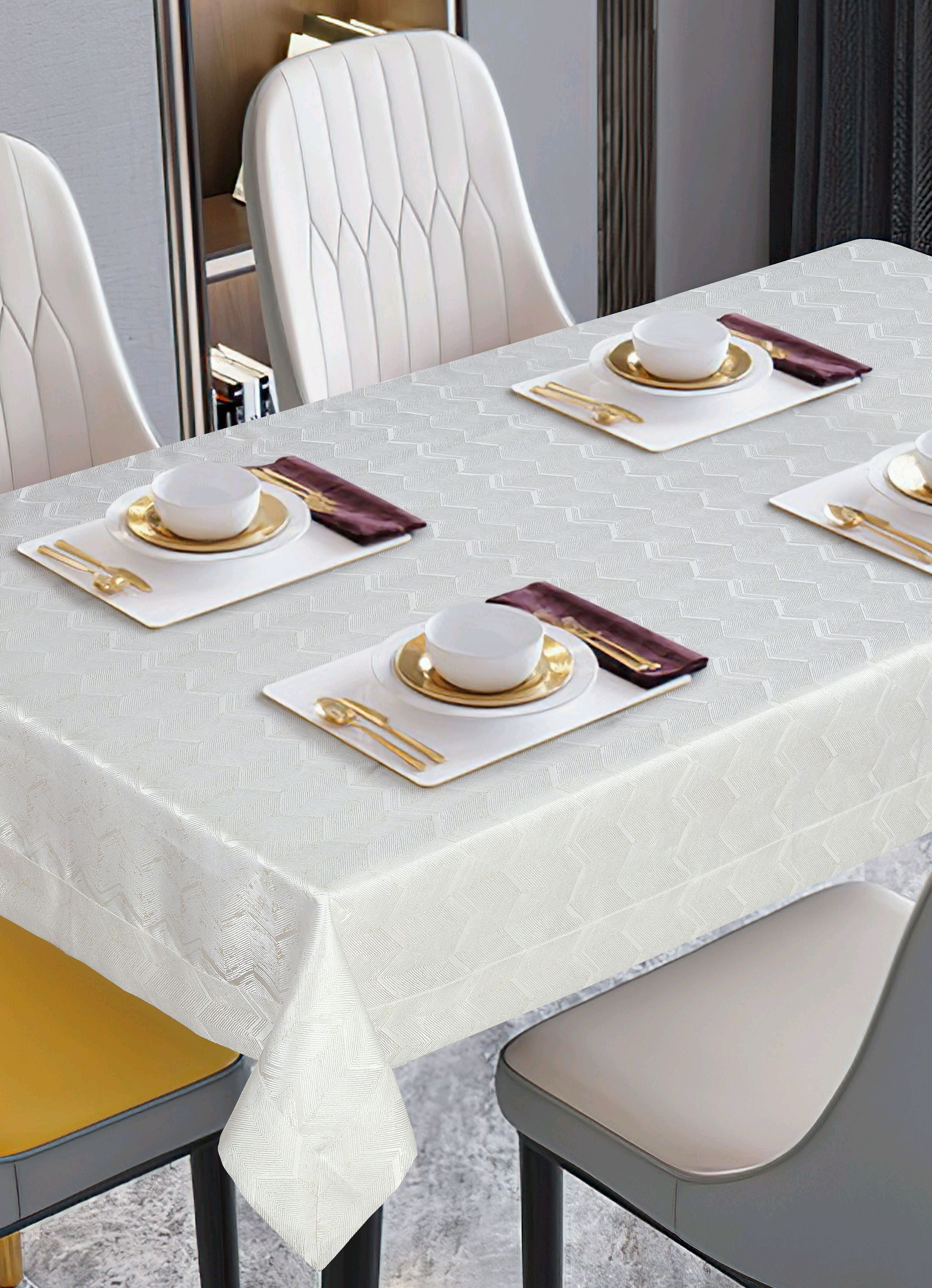 White tone-on-tone woven damask tablecloth with a subtle zigzag texture on a modern table