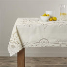 Cream tablecloth with cutwork floral embroidery along the border and corner medallions
