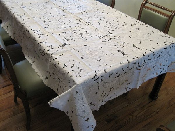 White hand-embroidered cutwork tablecloth with a grape-and-vine openwork pattern