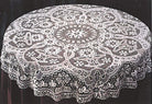 White openwork lace tablecloth with a central rosette medallion and deep scalloped border on a dark surface