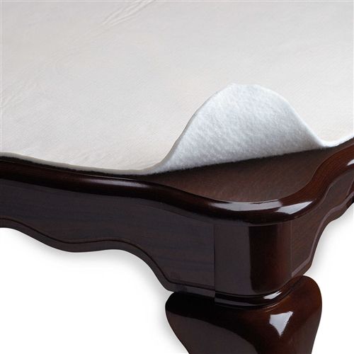 White cushioned flannel-backed table pad protector shown on a dark wood table corner