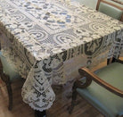 Ivory openwork lace tablecloth with medallion panels and a scalloped edge
