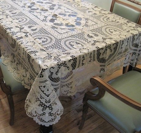 Ivory openwork lace tablecloth with medallion panels and a scalloped edge