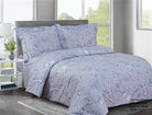 Periwinkle-blue cotton duvet set printed with trailing white blossom branches, with matching shams