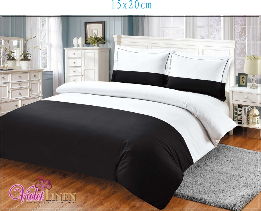 Black and white colour-block cotton sateen duvet set with matching shams on a bed
