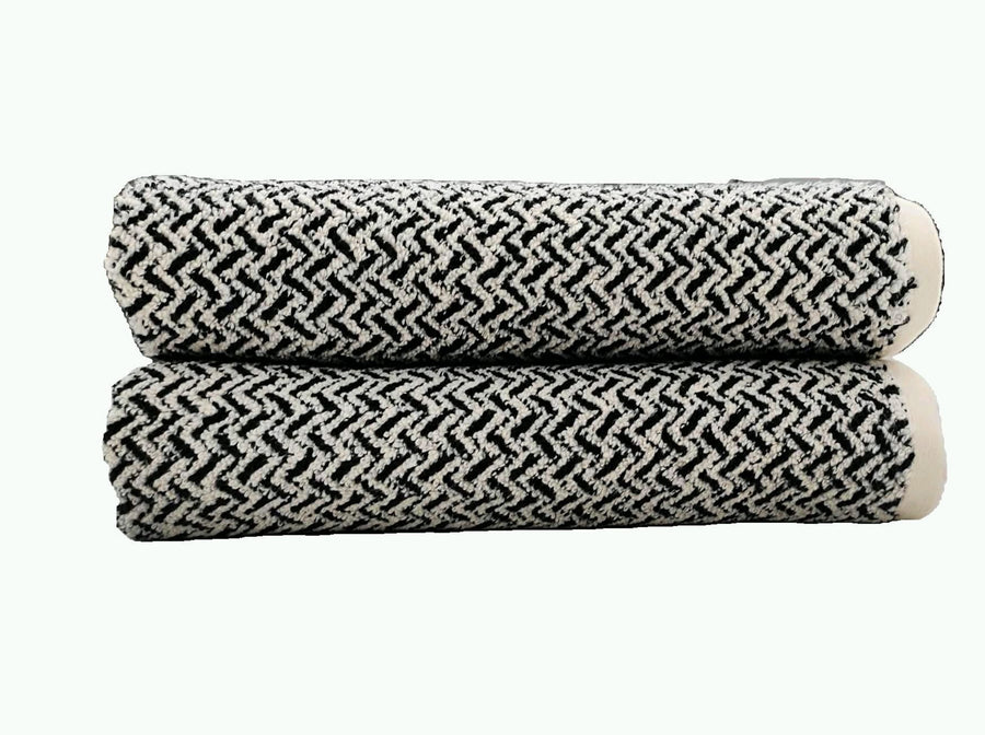 Black and white woven chevron zigzag terry towels, rolled and stacked
