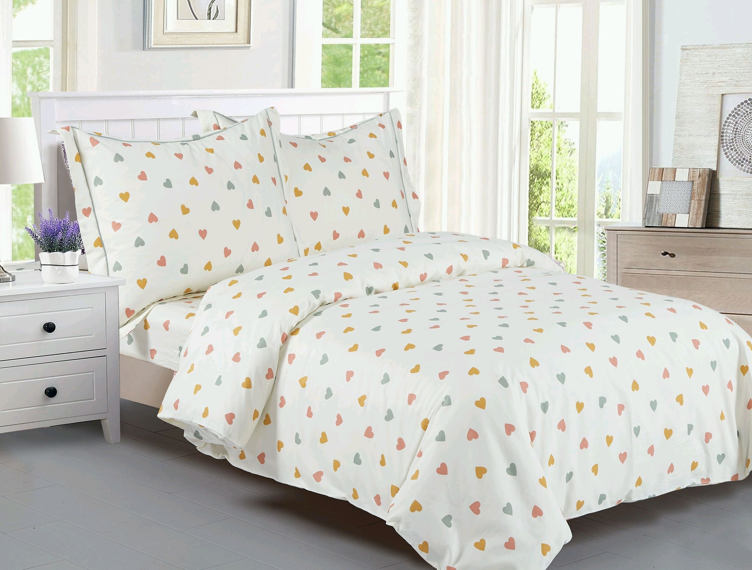 Cream cotton kids' duvet set printed with small coral, gold and green hearts, with matching shams