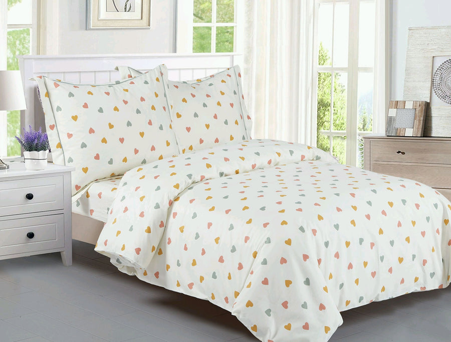 Cream cotton kids' duvet set printed with small coral, gold and green hearts, with matching shams
