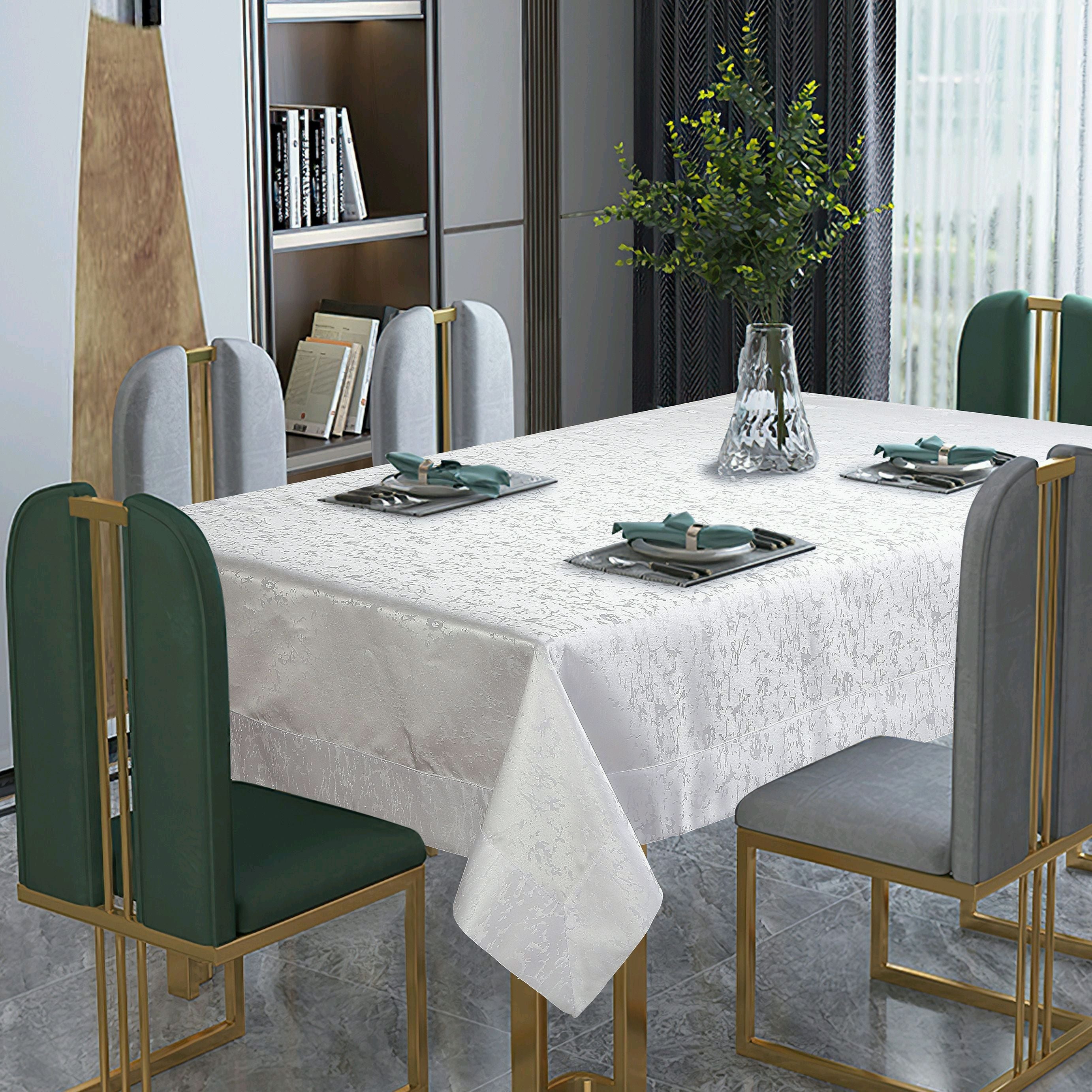 White tone-on-tone damask tablecloth with a woven floral pattern on a dining table