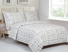 White cotton duvet set printed with a hand-drawn navy windowpane grid check, with matching shams
