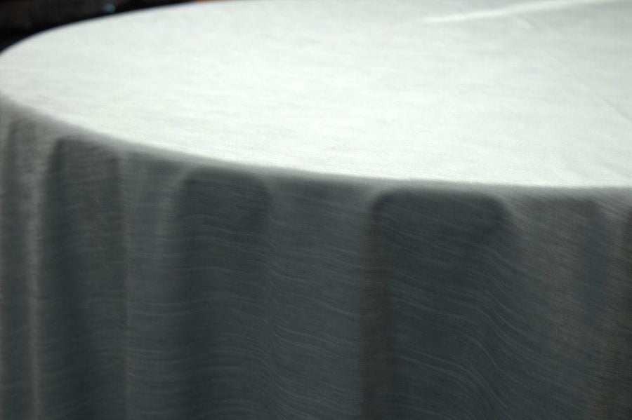 Elegant white tablecloth with a smooth texture draping over a round table.