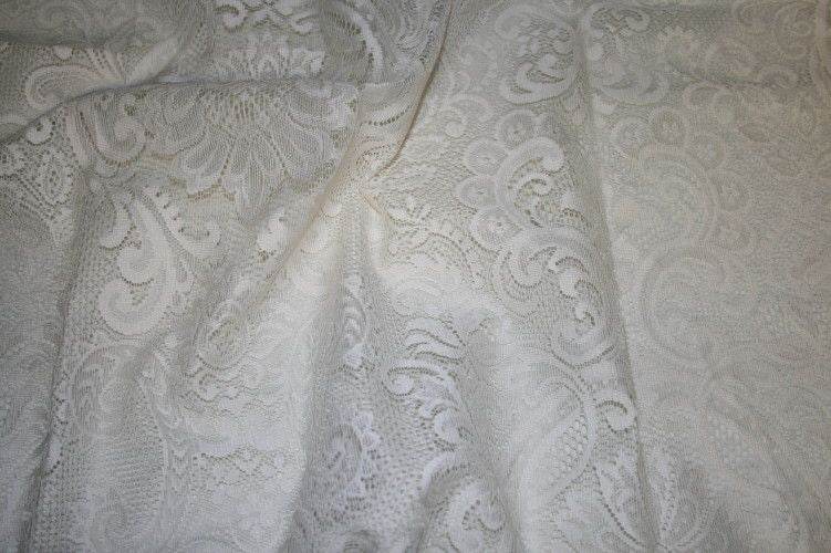 Ivory Damask Fabric featuring intricate floral patterns and a soft texture.